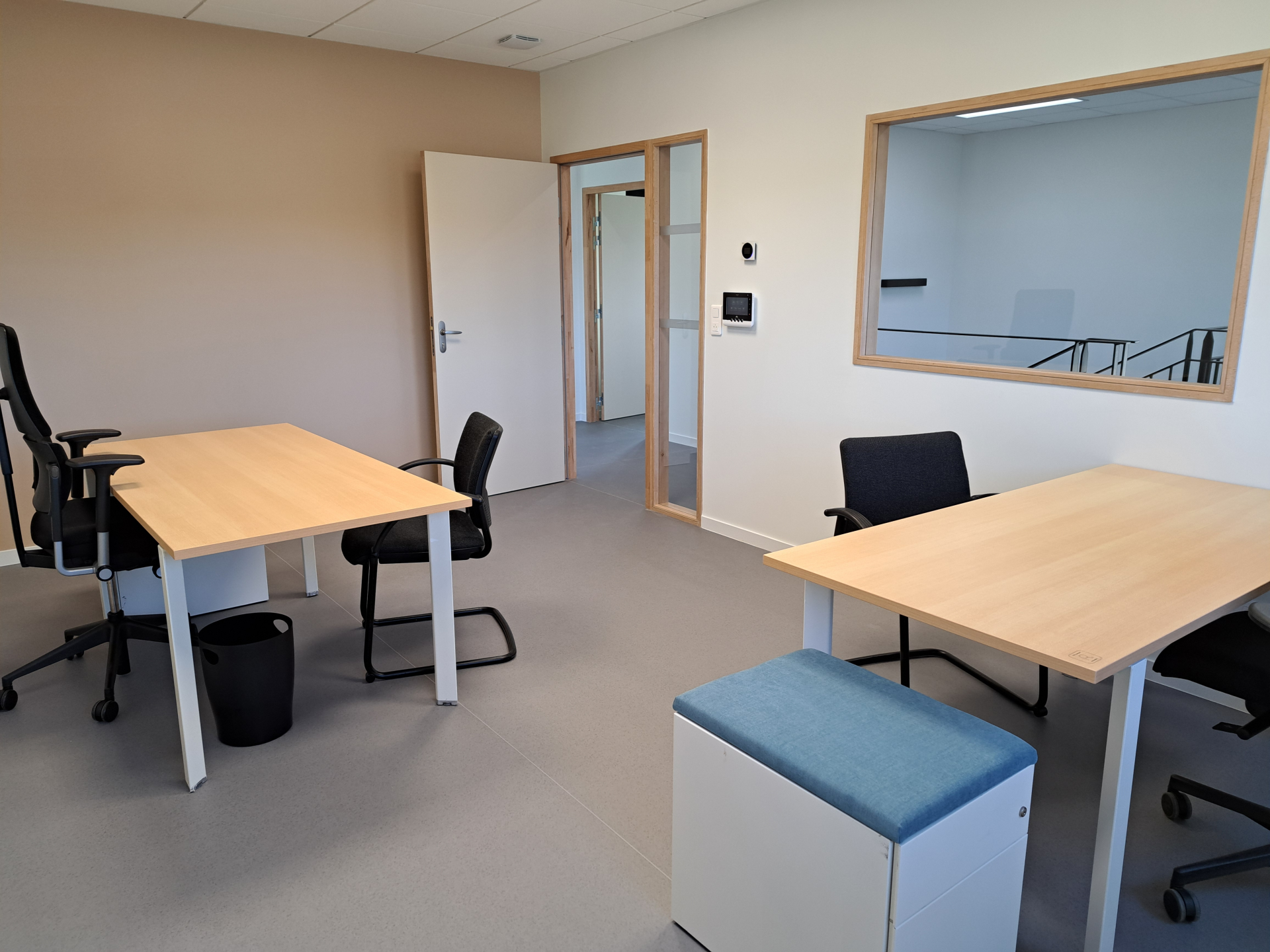 Bureau avec tables, chaises, poubelle et coussin. Porte et miroir.