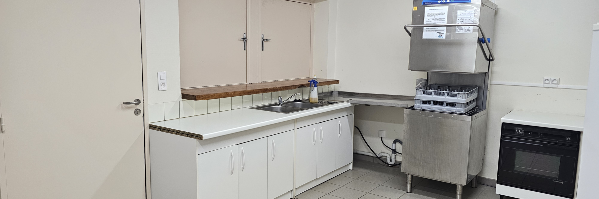 Cuisine avec lave-vaisselle, four, évier, plan de travail et portes.