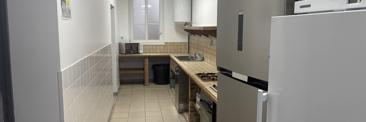 Cuisine avec réfrigérateur, four, plaque de cuisson, évier et meubles.