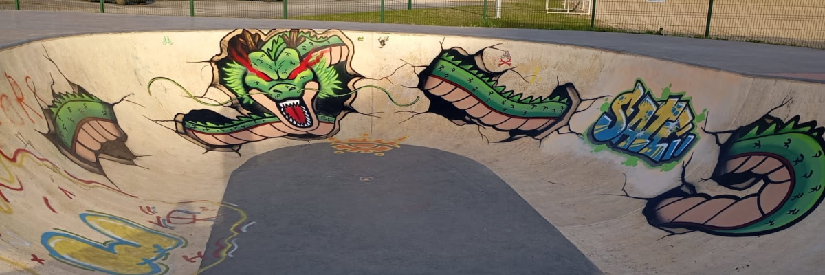 Skatepark avec graffitis de dragons colorés.