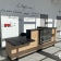 Réception avec bureau en bois, écrans, clavier, souris, et inscriptions murales.