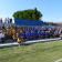 Stade avec tribunes, pelouse, et spectateurs.