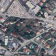Vue aérienne d'un quartier avec rues, bâtiments, écoles, parkings et commerces.