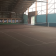 Salle intérieure avec terrain de tennis, filets, cibles de tir à l'arc et éclairage.